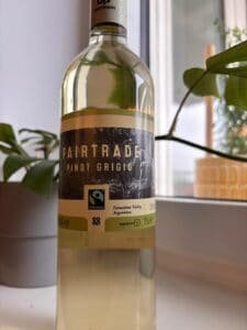 botthel of white wine in a backdrop with a plant and a yellow planter
